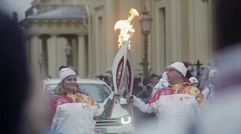 Relay race Olympic flame in Saint Petersburg in October. Adult torchbearer pass Stock Footage 62745149