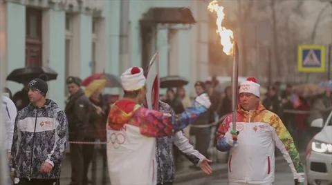 Relay race Olympic flame in Saint Petersburg in October. Torchbearer pass  flame Stock Footage 62877376