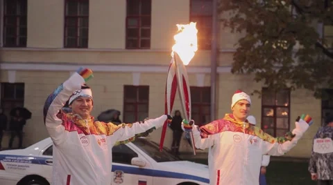 Relay race Olympic flame in Saint Petersburg. Torchbearer pass flame to another Stock Footage 62879382