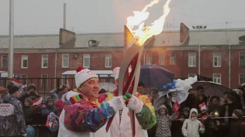 Relay race Olympic flame in Saint Petersburg. Bari Alibasov pass flame to Stock Footage 62879648