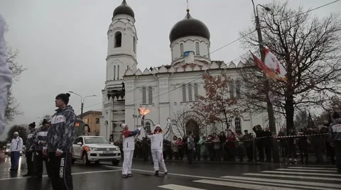 Relay race Olympic flame in Saint Petersburg. Torchbearer pass flame to woman Stock Footage 62879868