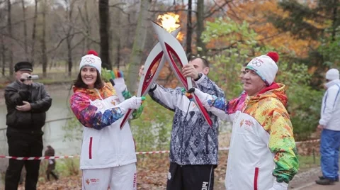 Relay race Olympic flame in Saint Petersburg. Torchbearer pass flame to man Stock Footage 62879940
