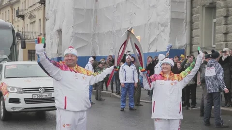 Relay race Sochi Olympic torch in Saint Petersburg. Torchbearers pass flame Stock Footage 62743384