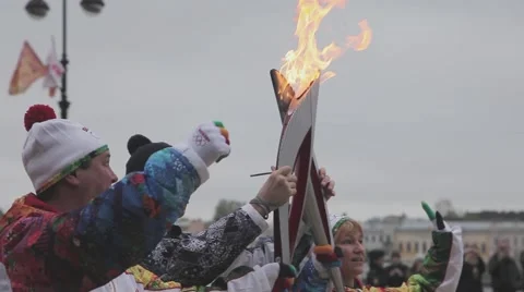 Relay race Sochi Olympic torch in Saint Petersburg. Moment of torchbearers pass Stock Footage 62743440