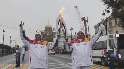 Relay race Sochi Olympic torch in Saint Petersburg. Torchbearers pass flame Stock Footage 62743445