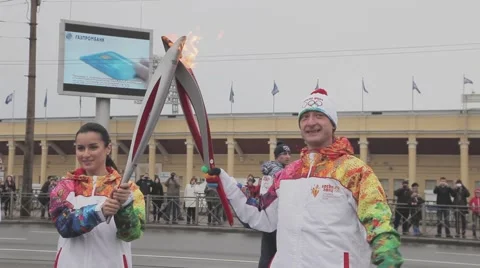 Relay race Sochi Olympic torch in Saint Petersburg. Plushenko pass flame to Stock Footage 62743534
