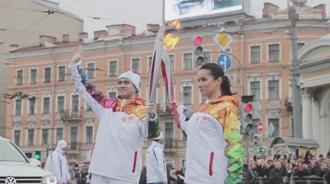 Relay race Sochi Olympic torch in Saint Petersburg. Kandelaki pass flame to Stock Footage 62743552