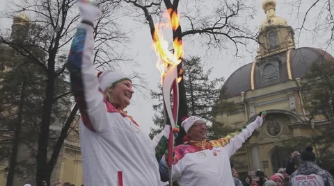 Relay race Sochi Olympic torch in Saint Petersburg. Torchbearer pass flame. Wave Stock Footage 62743766