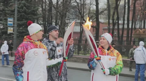 Relay race Sochi Olympic torch in Saint Petersburg. Female torchbearer pass Stock Footage 62743892