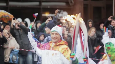 Relay race Sochi Olympic torch in Saint Petersburg. Torchbearer pass flame Stock Footage 62744670