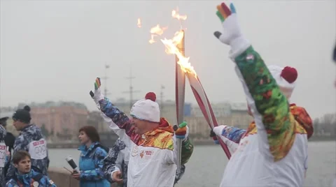 Relay race Sochi Olympic torch in Saint Petersburg. Torchbearers pass flame wave Stock Footage 62745077