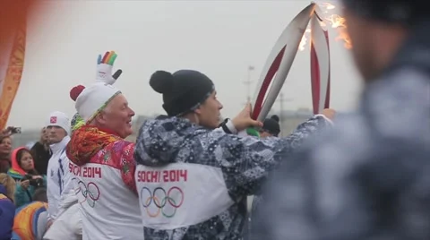Relay race Sochi Olympic torch in Saint Petersburg. Back side torchbearers pass Stock Footage 62745078