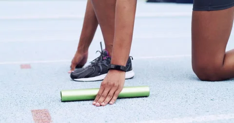 Relay runner, hands and baton for race at starting line, sports track and Vidéo 243199188