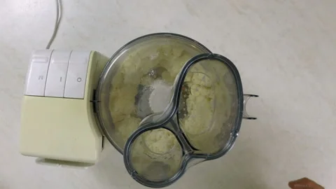 Release dough from food processor into bowl Stock Footage 98457988