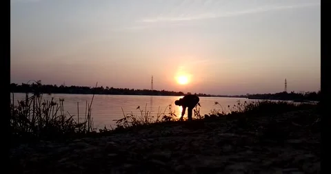 Release snails into the river Stock Footage 297725574