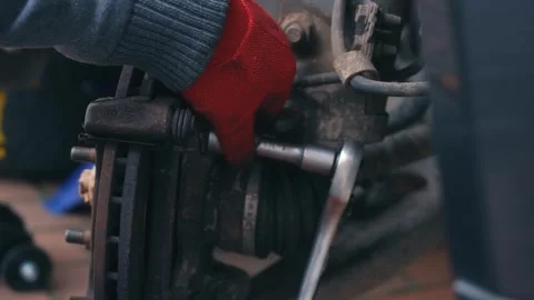 Releasing brake assembly hardware with hand tools during vehicle disassembly Video stock 337417780