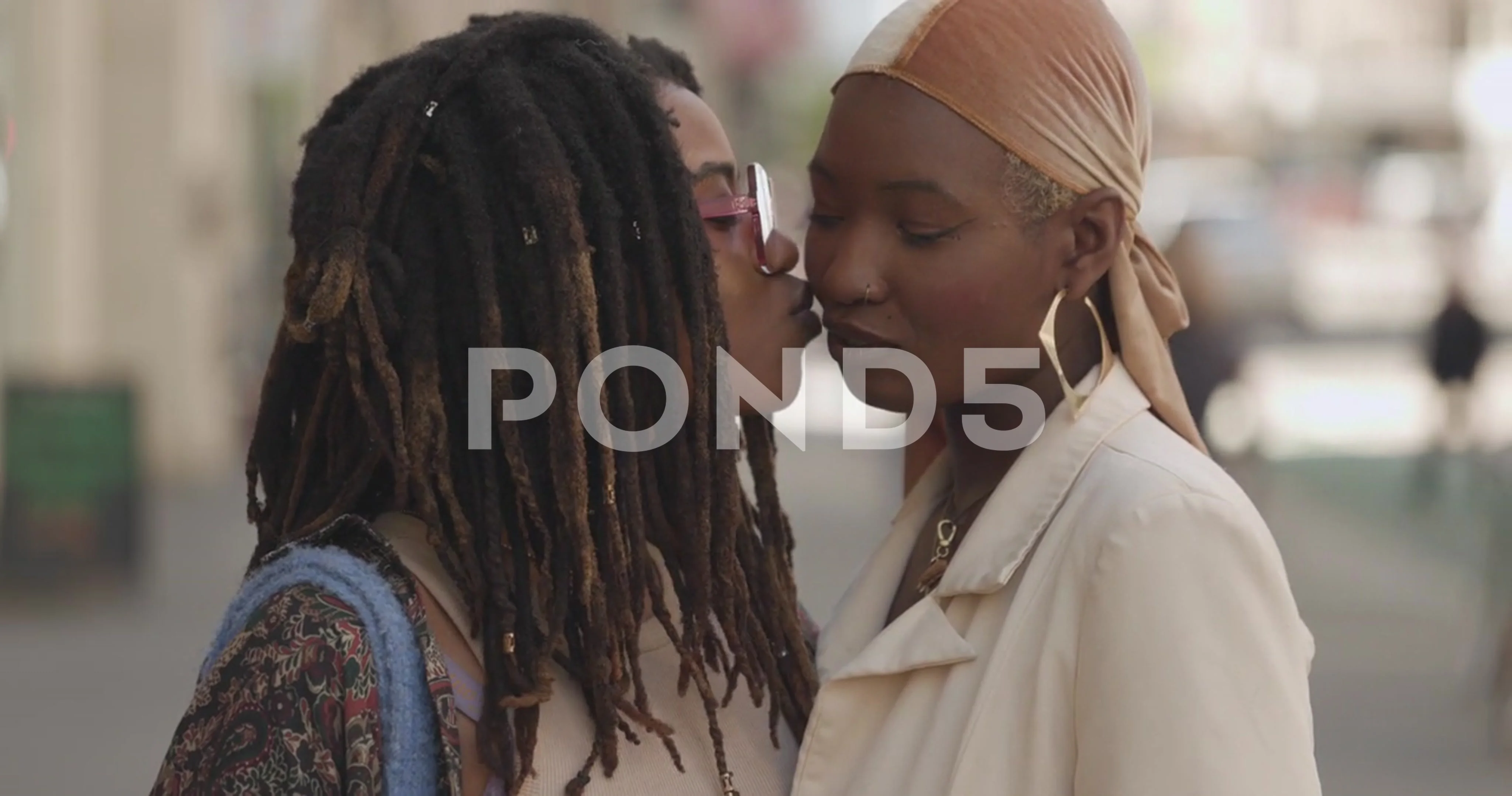 ReLGBTQ LGBT black women same sex lesbian couple portrait on city street  kissing