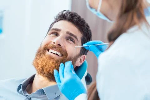 Reliable dentist using sterile instruments while cleaning the te 스톡 사진