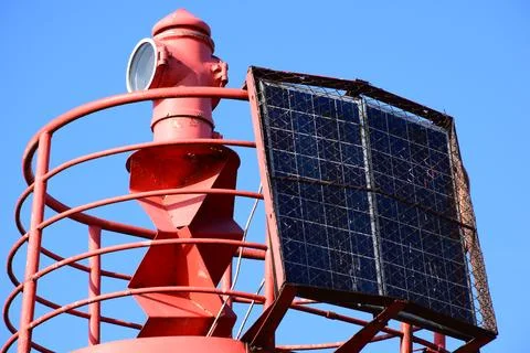 Reliable Red Navigation Aid Tower for Maritime Traffic in City Port Area Stock Photos