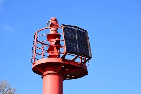 Reliable Red Navigation Aid Tower for Maritime Traffic in City Port Area Stock-Fotos