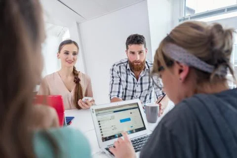 Reliable young co-workers thinking of solutions and successful ideas Stock Photos