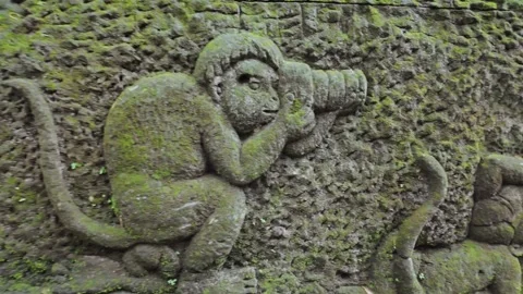 Relief carving of monkey holding camera phone. Ubud, Bali, Indonesia. Video stock 271567693