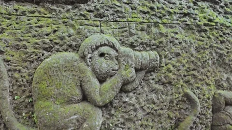 Relief carving of monkey holding camera phone. Ubud, Bali, Indonesia. Video stock 271567717