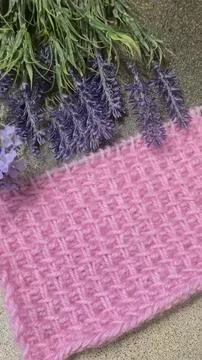 A relief openwork pattern knitted with colored yarn on a wooden background Stock Photos