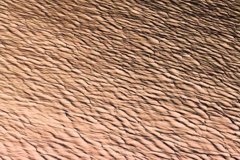 Relief representation of a rippled abstract surface in beige color Foto stock
