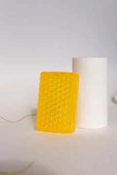 Relief solid yellow soap in light background. Stock Photos