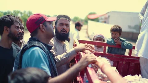 Relief workers helping flood victims in Jalalpur Pirwala Punjab Pakistan Stock Footage 319054103