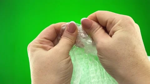 Relieve stress air bubble wrap in hands of woman she presses bubbles that burst Stock Footage 231343984