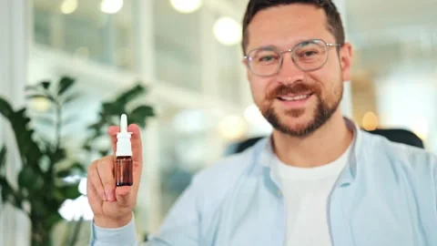 Relieved Man Smiling, Holding Nasal Spray for Health Stock Footage 318772839