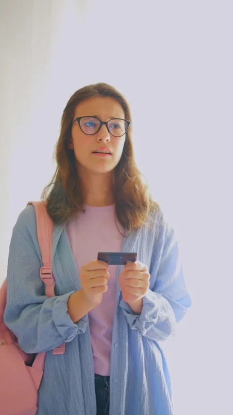 Relieved student finding solution to financial problem on white background. Stock Footage 312640249