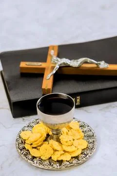 Religious communion setting with wine, bread, crucifix during morning devotion Stock Photos