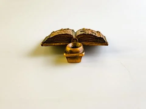 Religious copper candlestick in the form of an open bible and a place for a.. Stock Photos