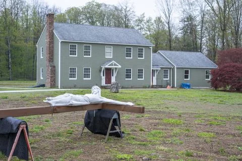 Religious Crucifix Statue Undergoing Installation Outside Parish House Stock Photos