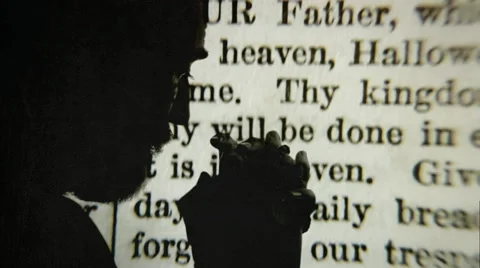 Religious man praying, bible projection in background Stock Footage