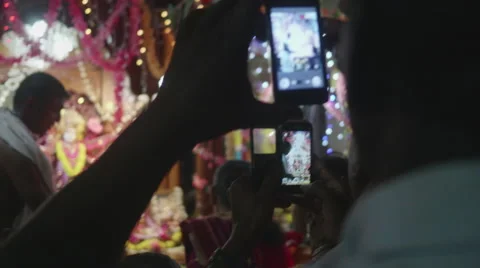 Religious man taking photo at ceremony with smartphone Stock Footage 60689918