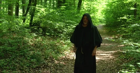 Religious monk makes a walking pilgrimage through the forest preserving traditio Stock Footage 336694525