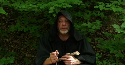 Religious monk performs prayer and spiritual practice in a forest environment. Stock Footage 336693882