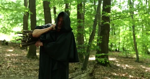 Religious monk spends time in forest silence combining physical labor with spiri Stock Footage 336694927