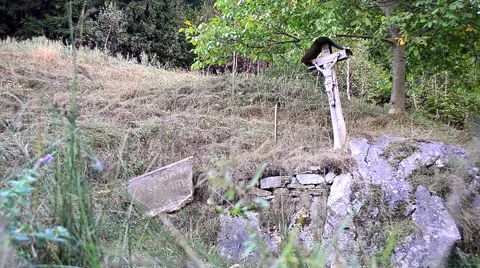 Religious monument built near a trail, under a walnut young Stock Footage 63390413