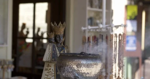 Religious objects for sale and incense burning at Altötting, Germany Stock Footage 113913318