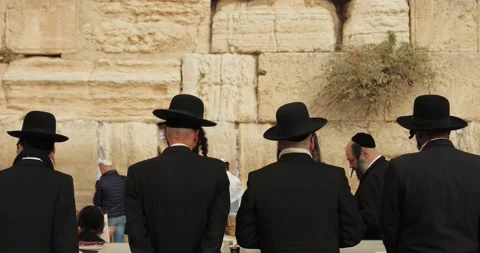 Religious people pray at the Western Wall in Jerusalem Israel Stock Footage 146489367