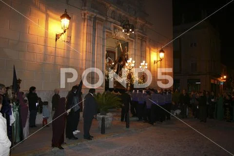 Religious people walking in procession for the Holy Week Semana Santa in Spa Stock Photos