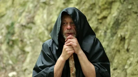 Religious pilgrim looks upward while remaining focused on his spiritual path. Video stock 336784882