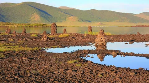 Religious stone structures on lakeshore Stock Footage 32423395