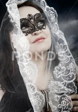 Religious woman with white veil in a position to pray Stock Photos