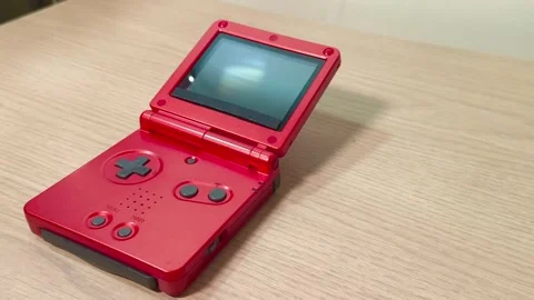 Relive the Retro Gaming Era with this Vibrant Red Handheld Console in Action, Video stock 318310941